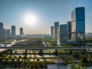 a city skyline with tall buildings and a freeway at Novotel Xi'an Aden in Xi'an