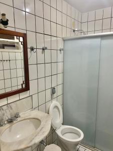 a bathroom with a toilet and a sink and a shower at CASA EM GUARAPARI in Guarapari +44 photos