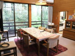 a dining room with a table and chairs at ～みらい荘～　天然温泉付き一日一組様限定の６４坪広々民泊別荘 in Kirishima