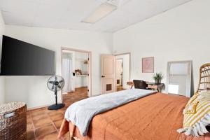 a bedroom with a large bed and a fan at Spacious House in Roundrock in Round Rock