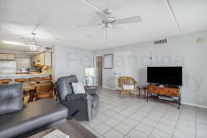 a living room with a couch and a table at Oceanfront Condo w Balcony in Amelia Island