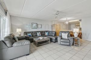 a living room with a couch and chairs and a table at Oceanfront Condo w Balcony in Amelia Island