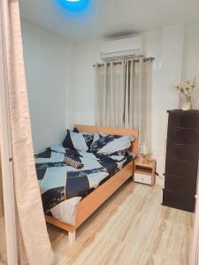 a bedroom with a bed with a wooden frame at Catalena Transient House Bayugan City in Bayugan City