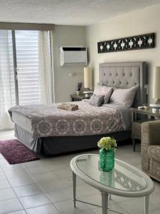a bedroom with a bed and a table and a couch at Tranquil & Cozy Studio Near Tmobile District. in San Juan