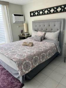 a bedroom with a large bed with a bed sqor at Tranquil & Cozy Studio Near Tmobile District. in San Juan