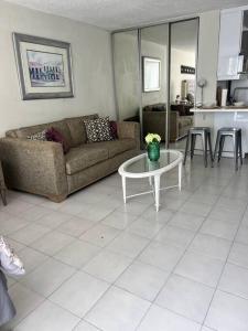 a living room with a couch and a table at Tranquil & Cozy Studio Near Tmobile District. in San Juan