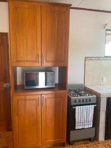 a kitchen with a microwave and a stove at Casas La Chirincoca in San Isidro de El General