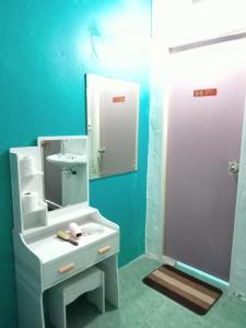 a bathroom with a white sink and a mirror at TIKI HOSTEL in Haad Rin