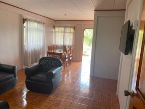 a living room with a couch and chairs and a table at Casas La Chirincoca in San Isidro de El General