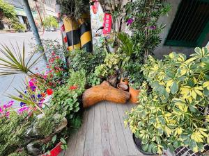 a garden with plants and a stuffed animal laying on a porch at Xingang Homestay in Xingang