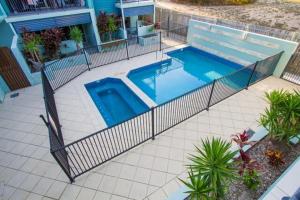 an overhead view of a swimming pool in a house at Beach Pad 2 - Modern 2-bed unit by the beach in Agnes Water