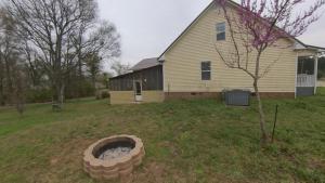 a yard with a fire pit in front of a house at River Dream Lake Murray Getaway in Saluda