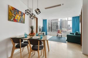 a dining room with a table and chairs in a living room at Vortex KLCC Apartments in Kuala Lumpur