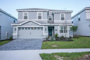 a white house with a garage at 1581 PD - Exquisite 6BR Haven: Private Pool in Davenport