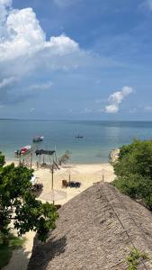 a beach with chairs and a plane in the water at Hostel Beach House in Rincón