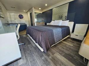 a bedroom with a large bed and a bathroom at Flamingo Inn in Rosemead