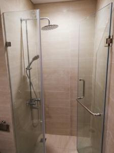 a shower with a glass door in a bathroom at May house Green Bay Garden Hạ Long - near Marina beach in Ha Long