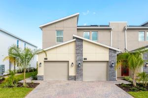 een huis met twee garagedeuren bij 1169 CD - Game Room Condo: Pool Disney Nearby in Kissimmee