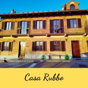 an old building with a bench in front of it at Casa Rubbo - Appartamento in collina 'Monviso' in Alba