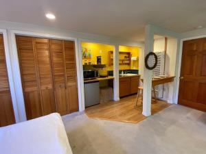 a room with a kitchen with wooden cabinets and a counter at Garden Cottage Paradise Also Perfect for WFH-ers in Mountain View