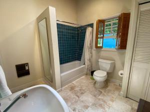a bathroom with a tub and a toilet and a sink at Garden Cottage Paradise Also Perfect for WFH-ers in Mountain View
