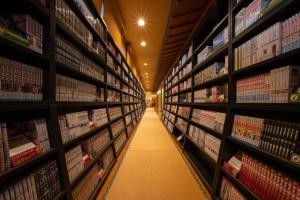 a aisle in a store with lots of books at Kami no yama Azumaya in Kaminoyama