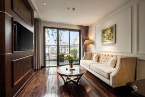a living room with a couch and a table at Anatole Hotel Hanoi in Hanoi