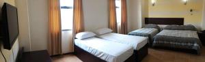 Postel nebo postele na pokoji v ubytování Metro Park Hotel Mandaue