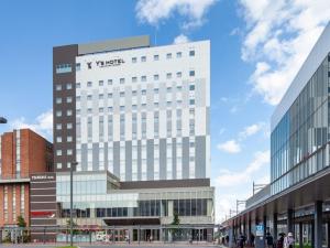 a tall white building with a sign on it at Y's Hotel Asahikawa Ekimae - Vacation STAY 65443v in Asahikawa
