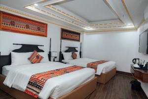 Postel nebo postele na pokoji v ubytování Trung Huyền Hotel