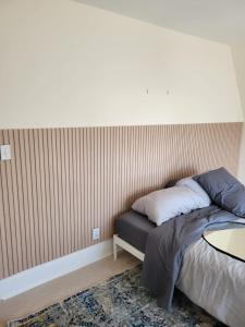 a bedroom with a bed and a table in it at Ottawa Downtown Cozy Guesthouse in Ottawa