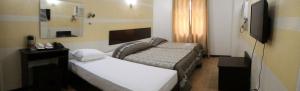 Postel nebo postele na pokoji v ubytování Metro Park Hotel Mandaue