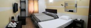 Postel nebo postele na pokoji v ubytování Metro Park Hotel Mandaue