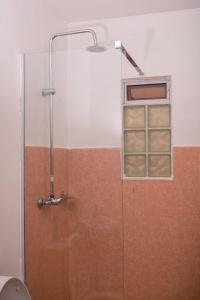a shower with a window in a bathroom at Unity homes #G08 in Eldoret