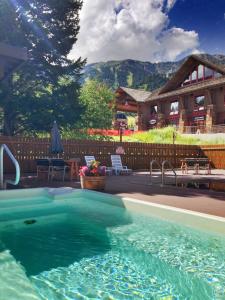 a large swimming pool in front of a house at The Alpenhof in Teton Village