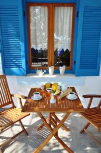 a table with a bowl of fruit on it in a room at Rena Valetta Studios in Naxos Chora