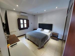 1 dormitorio con cama y ventana en El Castillo en Campana