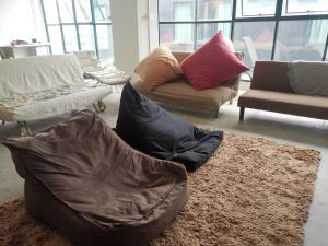 a living room with couches and pillows on a rug at Y.U.A.N in Kluang