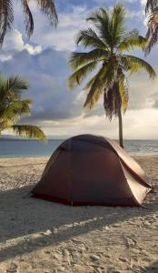 a tent on a sandy beach with palm trees at San Blas Gabin SDT in Mamartupo