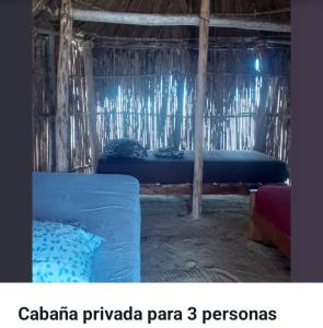 a room with a bed in a straw hut at San Blas Gabin SDT in Mamartupo