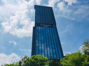 a tall blue building with a sign on it at Sky Pool 4 Star grade stay in i-City in Shah Alam