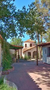 a large building with a tree in front of it at El Torreón Lodge in Potrerillos