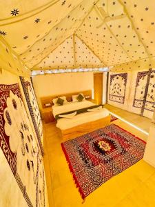 a room with a bed and a fireplace in a tent at Best Desert Camp In Jaisalmer Red Velvet in Jaisalmer