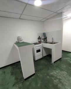 a kitchen with a stove and a sink in it at Apartamentos - Brisas del Mirador - Panamá Campestre 