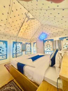 a bedroom with a large bed in a room at Best Desert Camp In Jaisalmer Red Velvet in Jaisalmer