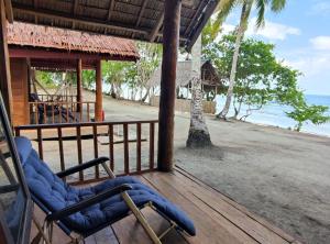 a porch of a resort with chairs on a beach at Famangkor Homestay in Yennanas Besir