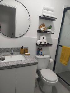 a bathroom with a toilet and a sink and a mirror at De lujo y exclusivo, con estacionamiento in Lima