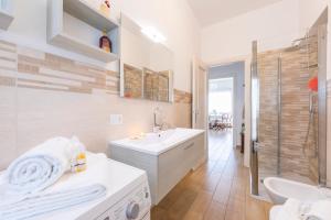 biała łazienka z umywalką i prysznicem w obiekcie Residenza La terrazza di Dante - Happy Rentals w mieście Stresa +18 zdjęć