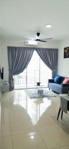 a living room with a blue couch and a large window at Bayu Temiang- Your Urban Retreat in Seremban