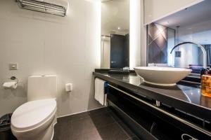 a bathroom with a white sink and a toilet at Spey Hotel - Foshan Ancestral Temple Subway Station in Foshan